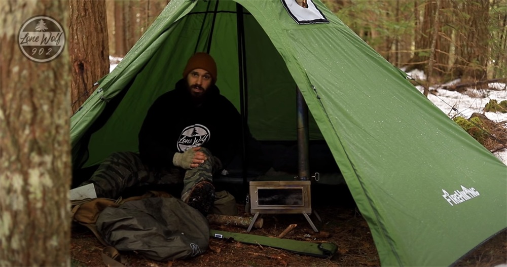 camping in firehiking hot tent with a wood stove