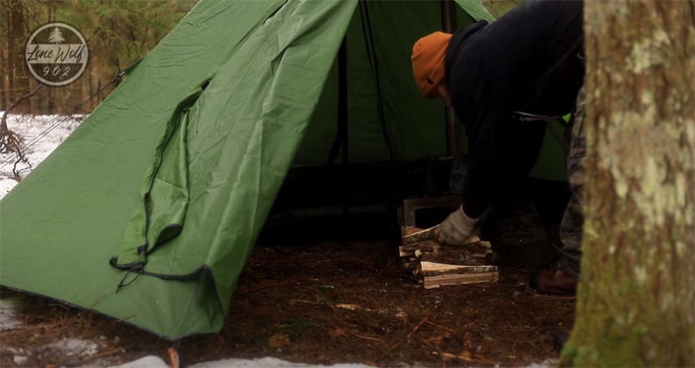 put wood in the firehiking hot tent